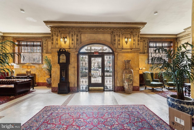 foyer entrance featuring crown molding