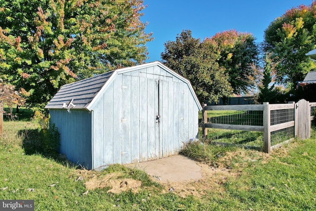 view of shed featuring fence