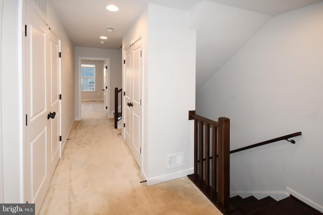 corridor featuring light carpet, visible vents, baseboards, an upstairs landing, and recessed lighting