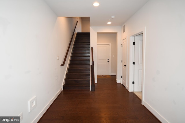 corridor with baseboards, visible vents, dark wood-type flooring, and recessed lighting