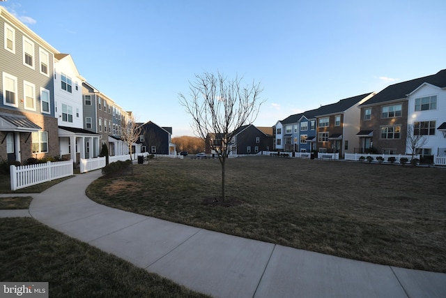 surrounding community featuring a yard, fence, and a residential view