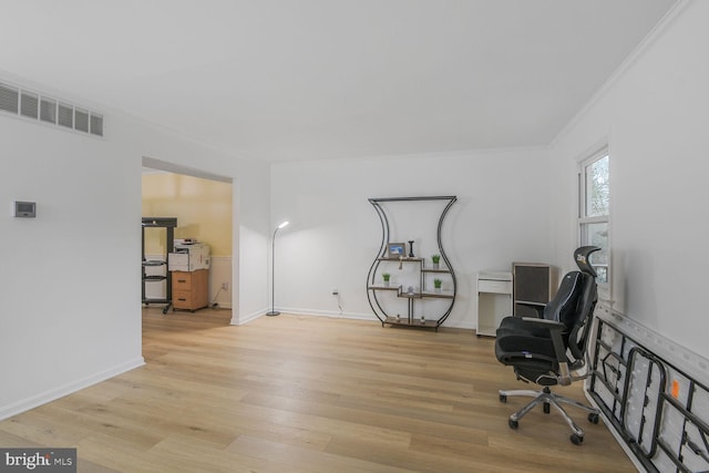 office featuring ornamental molding, visible vents, baseboards, and wood finished floors