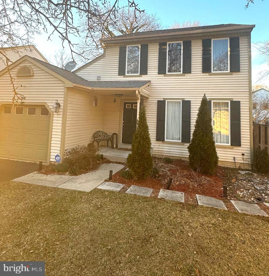 view of front facade featuring an attached garage and a front lawn