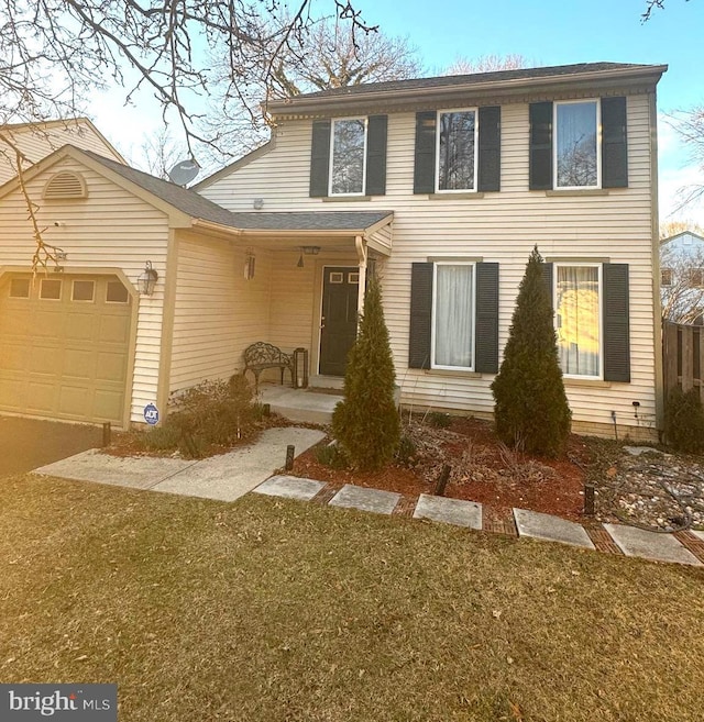 view of front facade featuring an attached garage and a front lawn