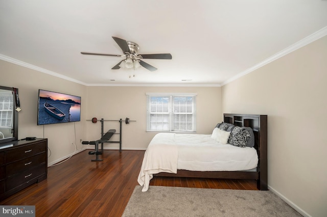 bedroom with baseboards, dark wood-style flooring, a ceiling fan, and crown molding