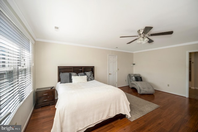 bedroom featuring ornamental molding, wood finished floors, a ceiling fan, and baseboards