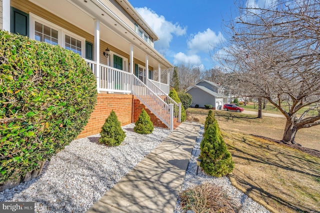 exterior space featuring stairs and a porch