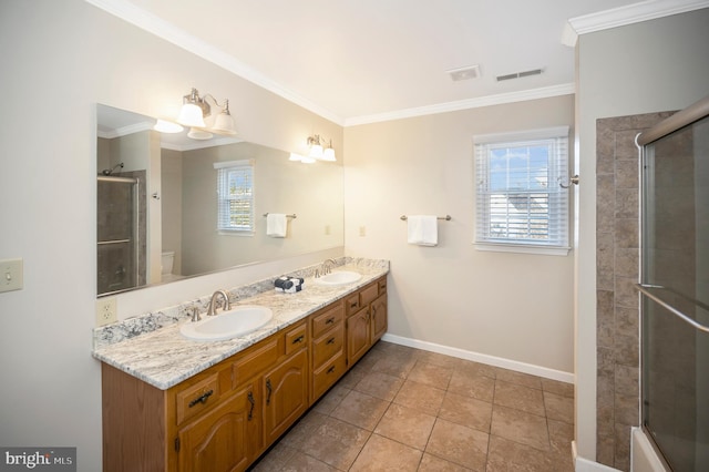 bathroom with a shower with door, toilet, ornamental molding, a sink, and baseboards