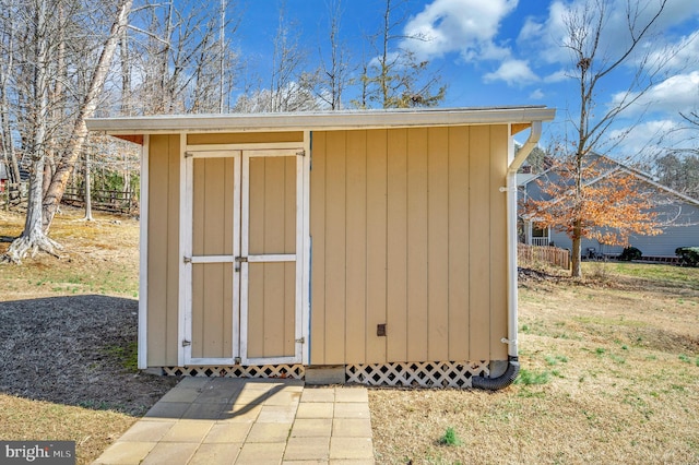 view of shed featuring fence