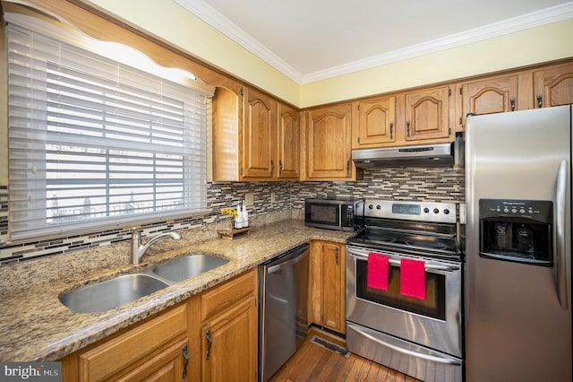 kitchen featuring stainless steel appliances, decorative backsplash, ornamental molding, a sink, and under cabinet range hood