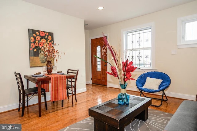 living area with recessed lighting, baseboards, and wood finished floors