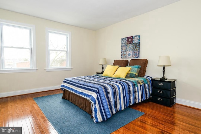 bedroom featuring wood-type flooring and baseboards