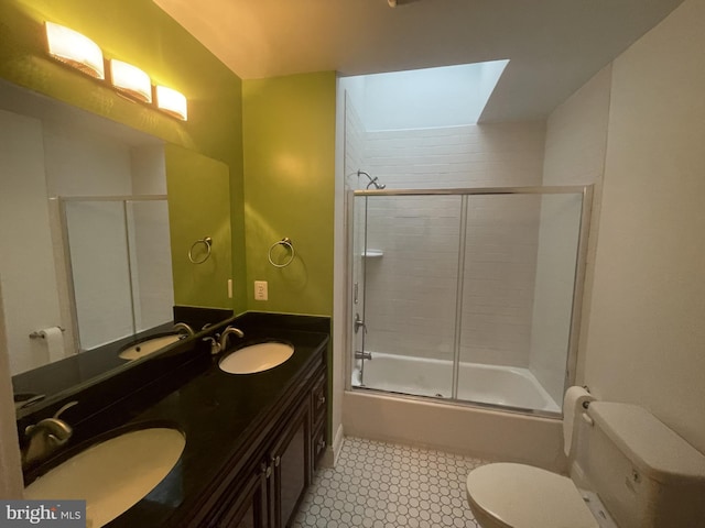 bathroom with a skylight, a sink, and toilet