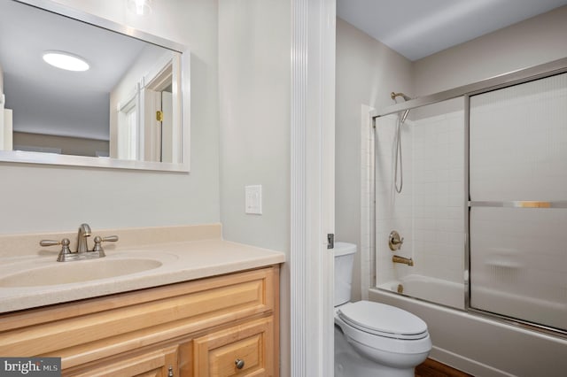 bathroom featuring shower / bath combination with glass door, vanity, and toilet