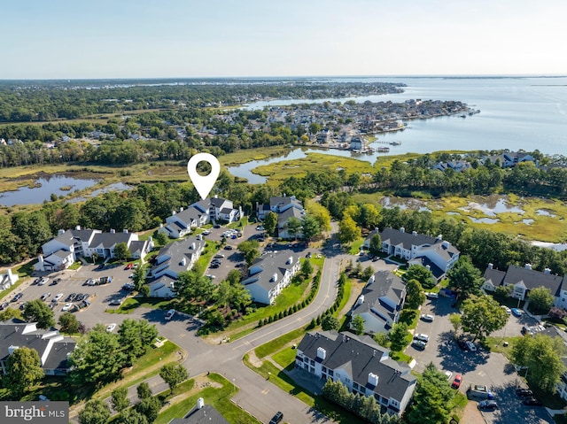 drone / aerial view with a water view and a residential view