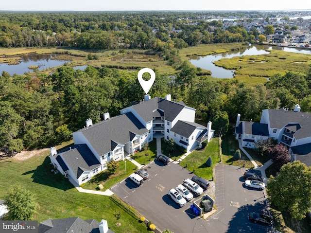 aerial view featuring a water view, a residential view, and a view of trees