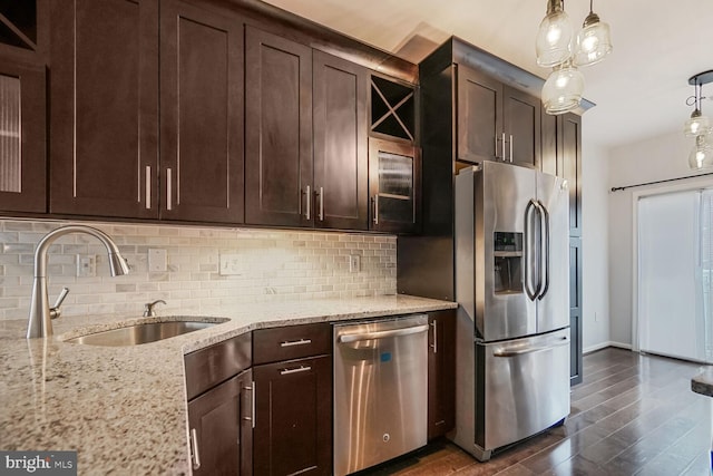 kitchen with a sink, dark brown cabinetry, and appliances with stainless steel finishes