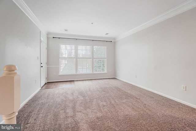 unfurnished room featuring visible vents, baseboards, carpet, and crown molding