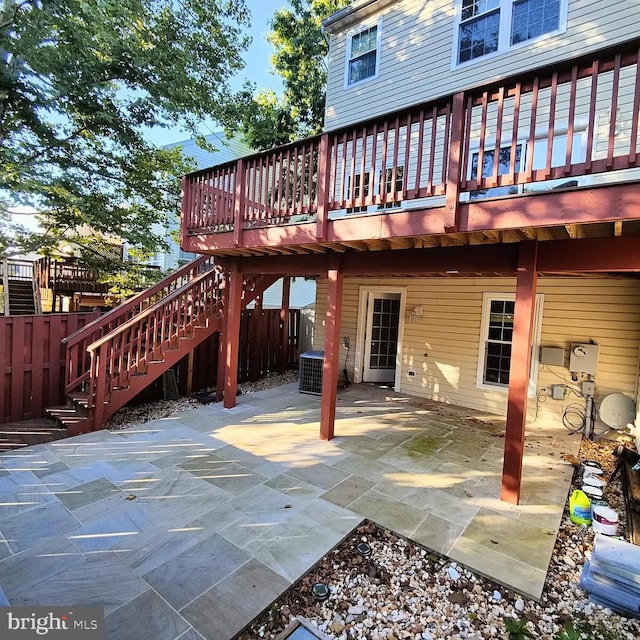 rear view of house featuring a wooden deck, a patio, and stairway