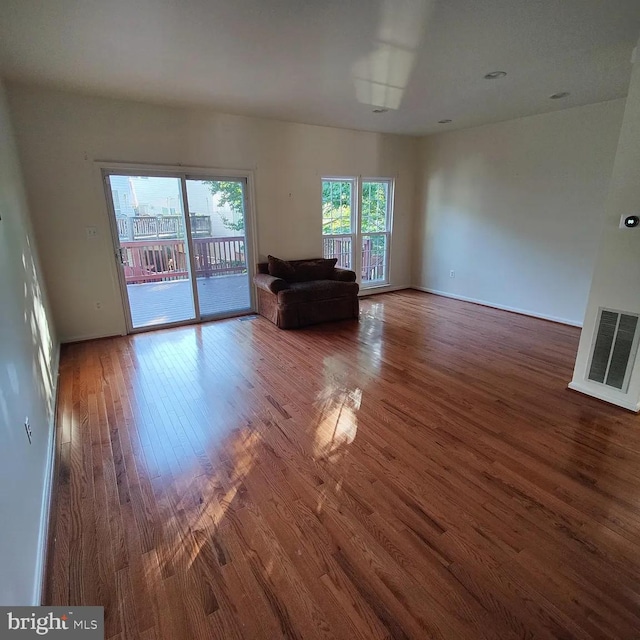 unfurnished living room with wood finished floors