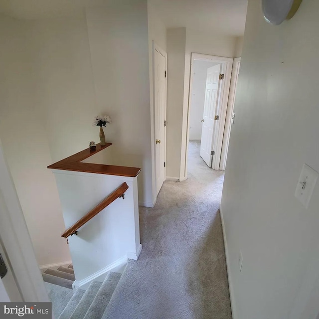 hall with light carpet and baseboards
