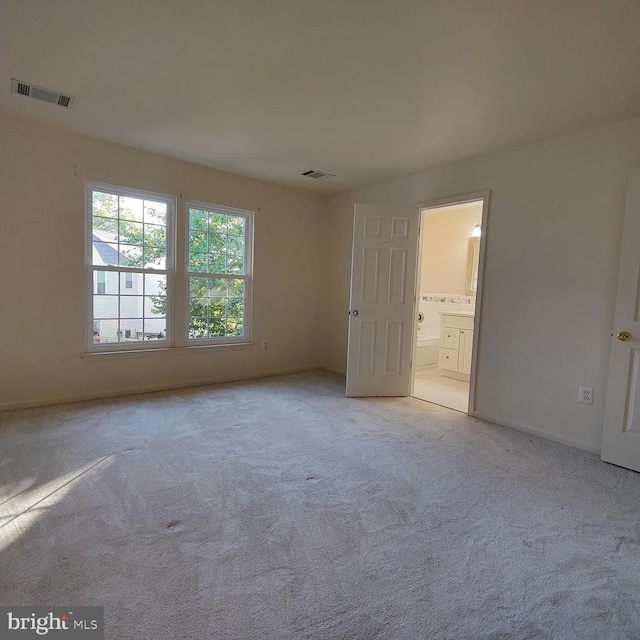 unfurnished room with carpet and baseboards