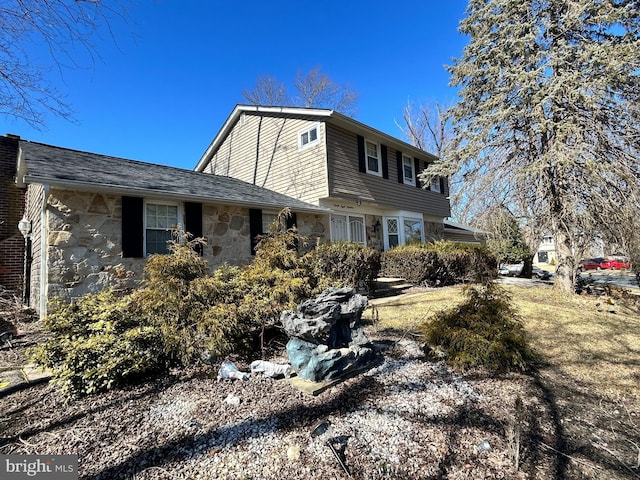 view of side of property featuring stone siding