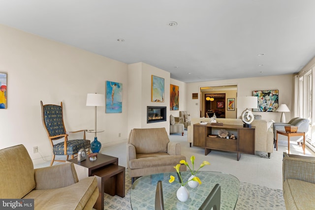 living area featuring recessed lighting, carpet, and a glass covered fireplace