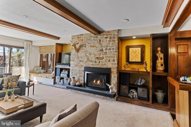 living area featuring carpet, a fireplace, and beam ceiling