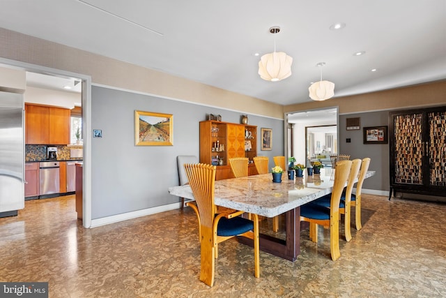 dining room with baseboards and recessed lighting