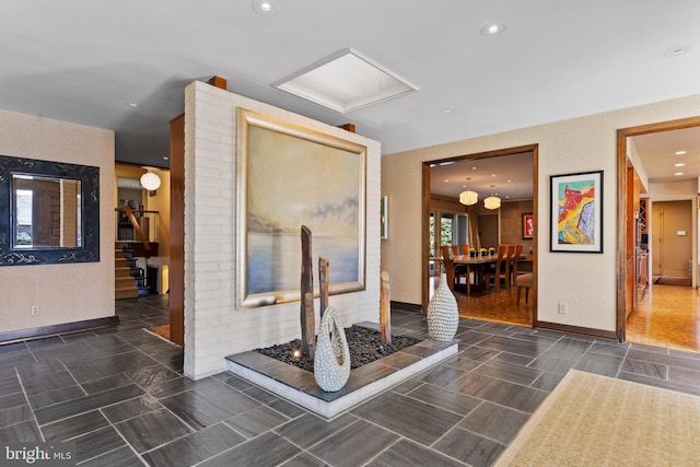 hall featuring recessed lighting and baseboards