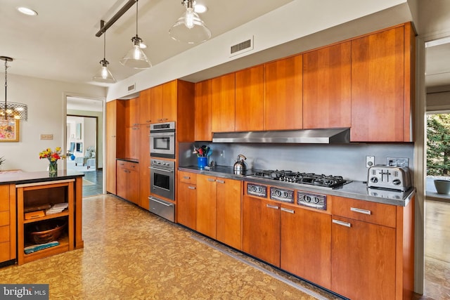 kitchen with visible vents, brown cabinetry, appliances with stainless steel finishes, range hood, and a warming drawer