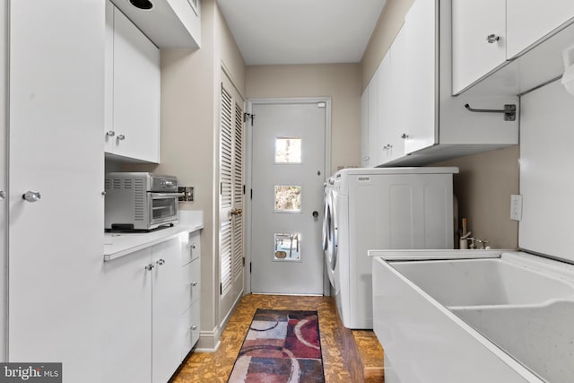 laundry room featuring a sink, washer / dryer, a toaster, and cabinet space