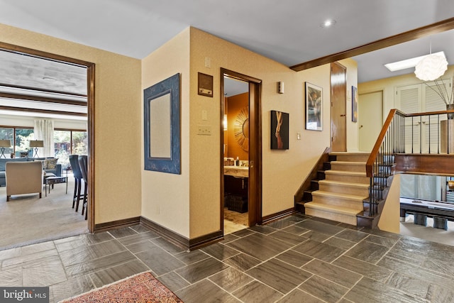 interior space featuring baseboards and stairway