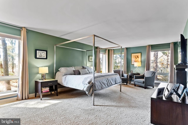 carpeted bedroom featuring multiple windows