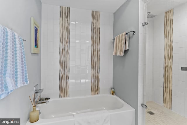 bathroom with a bathing tub and tiled shower