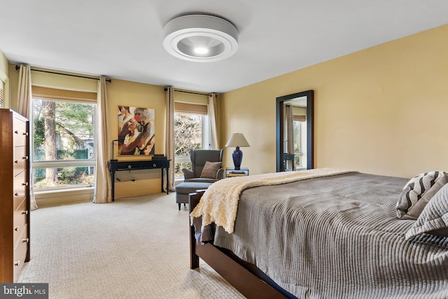 bedroom featuring light colored carpet