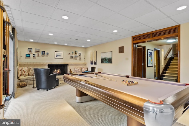 playroom featuring a paneled ceiling, carpet, a fireplace, and recessed lighting