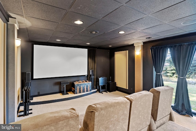 carpeted home theater room with a drop ceiling, visible vents, and recessed lighting