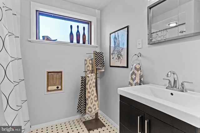 bathroom featuring vanity, baseboards, and tile patterned floors