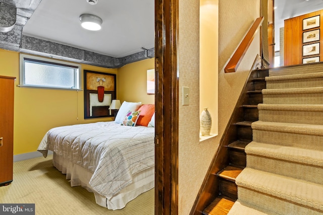 carpeted bedroom featuring baseboards