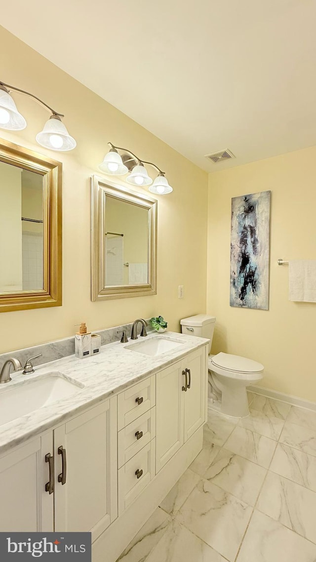 full bathroom featuring double vanity, visible vents, marble finish floor, and a sink