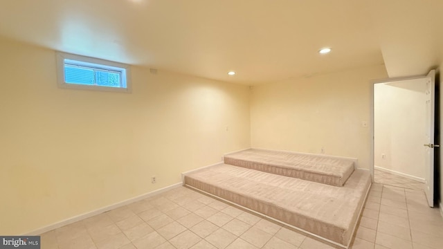 interior space featuring light tile patterned flooring, recessed lighting, and baseboards