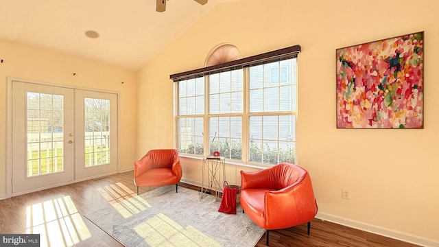 sitting room featuring lofted ceiling, wood finished floors, french doors, and a healthy amount of sunlight