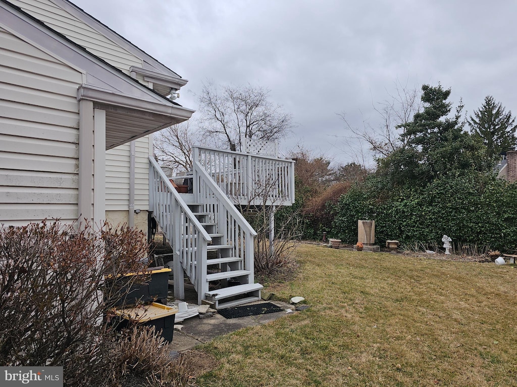 view of yard featuring stairway and a wooden deck