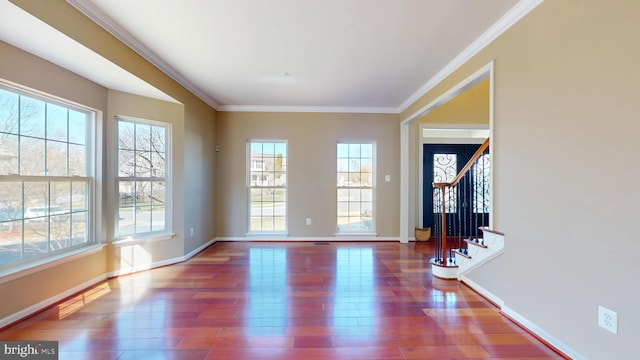 interior space featuring crown molding, stairway, wood finished floors, and baseboards