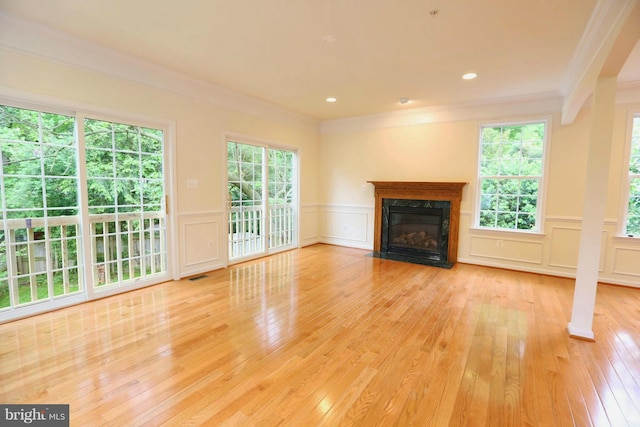 unfurnished living room with a fireplace, hardwood / wood-style flooring, and crown molding