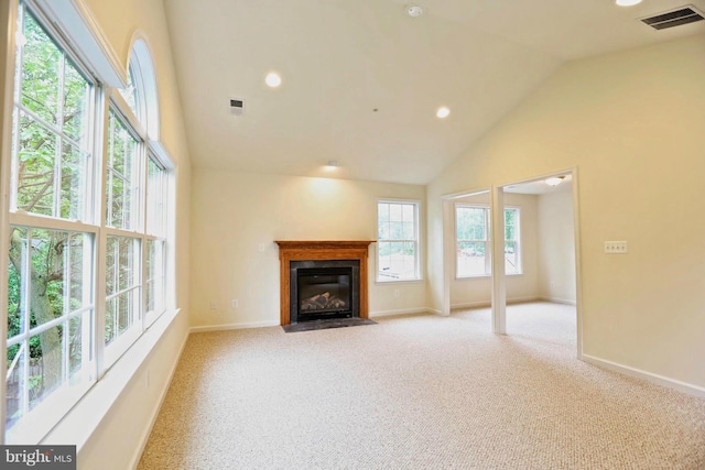 unfurnished living room featuring light carpet, a fireplace with flush hearth, visible vents, and baseboards