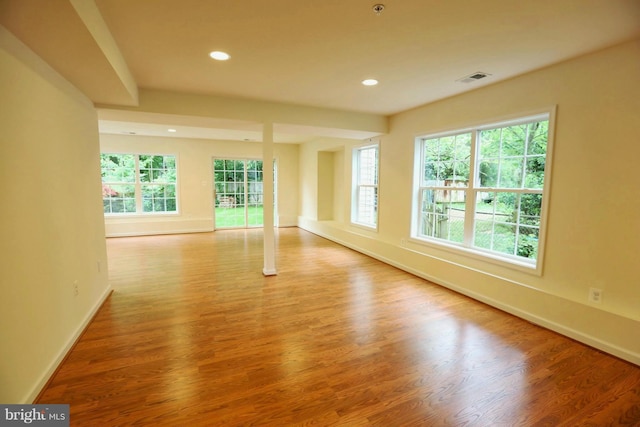 unfurnished room featuring recessed lighting, visible vents, baseboards, and wood finished floors