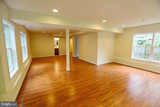 unfurnished room with recessed lighting, baseboards, and wood finished floors